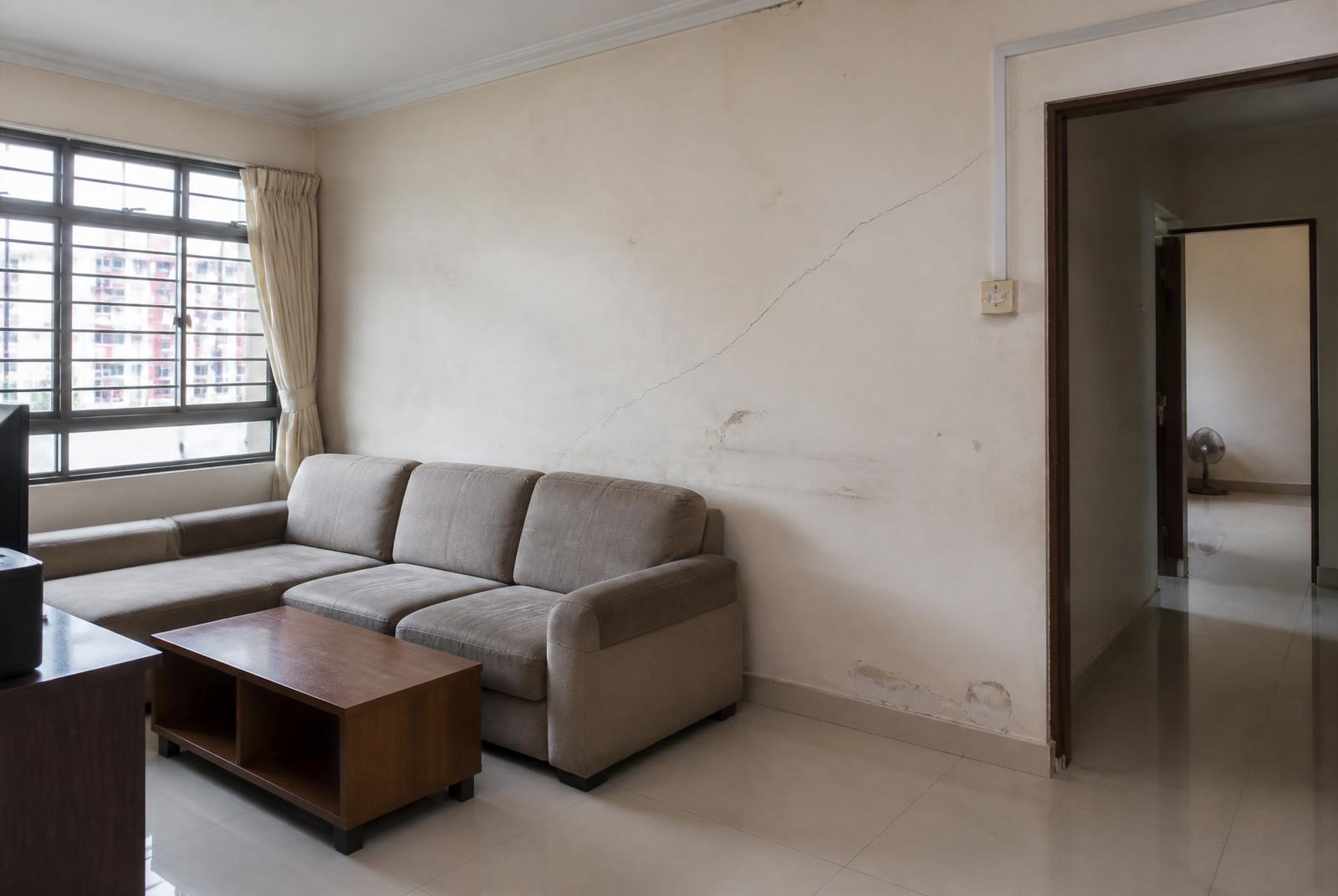 HDB living room with tired, cracked, stained walls before repaint
